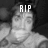 Grayscale pixelated image of a person with 'RIP' text overlaid on the forehead, dark background.