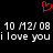 Red pixelated heart symbol above two identical lines of pixelated text reading '10 M2/08 i love you' on black background.