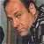 A 50x50 pixel buddy icon split into two frames showing a person's face on the left and green text on a dark background on the right, with visible pixelation and dithering effects.