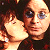 A 50x50 pixel animated buddy icon featuring a close-up of two people kissing on the left and green text reading "Original Icons .com" on the right against a dark background.