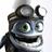 Pixelated static image of a cartoon character with large green eyes, dark hair tied in a ponytail, and a wide open mouth showing teeth.