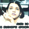 A person with dark hair and a cigarette in hand rests their chin on their hand, wearing a white fluffy garment against a blurred background with text overlays.