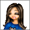 Pixelated cartoon girl with long brown hair, blue top, and pink mouth smiling against gray background.