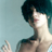 Pixelated static image of a person with dark hair and light skin in profile view against a teal background, featuring visible dithering and low-resolution rendering artifacts.