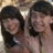 Two figures with dark hair in close proximity, one figure's face partially obscured by the other's head.