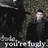 Pixelated static image shows a figure in dark clothing against a textured background with partial text at the bottom.