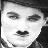 Black-and-white pixelated static icon of a human face with closed eyes and mustache, rendered in low-resolution grayscale with visible dithering and blocky artifacts.