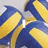 Blue and yellow striped volleyball with text overlays changing across four