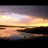 A static pixelated image showing a horizontal gradient of warm and cool tones transitioning from dark at the top to bright yellow-orange in the middle, with darker bands below.