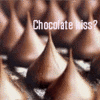Brown conical chocolate candies with smooth texture arranged in a grid pattern, overlaid with white text reading 'Chocolate kiss?'.