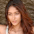 Static 50x50 pixel icon showing a close-up of a person with long brown hair against a textured background, rendered in low-resolution pixel art style.