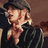 Pixelated image of a person with light hair wearing a dark cap and dark clothing, with text reading 'tumpalicious' in white pixelated font on the right side.