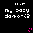 Black background with white pixelated text reading 'i love my baby darron<3' and two pink heart symbols at the bottom.