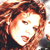 Pixelated close-up of a person with reddish-brown hair, closed eyes, and a neutral expression, wearing dark clothing against a light background.
