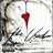 A static icon featuring a red heart-shaped object suspended by a thin line above abstract black and white brush strokes on a light background.