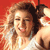Pixelated static image of a person with curly hair wearing a white top against a red background, rendered in low-resolution 256x256 pixels.