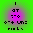 Green background with four identical purple circular gradients containing black pixelated text reading "i am the one who rocks".
