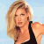 Static pixelated image of a person with blonde hair wearing a black sleeveless top against a light blue background.
