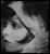 Black-and-white pixelated icon depicting a stylized abstract shape with curved lines and gradient shading on a dark background.