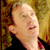 Static 50x50 pixel icon showing a close-up of a person's face with closed eyes and mouth slightly open, set against a blurred background with warm tones.