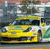 Yellow taxi cab in motion with blurred background, rendered in pixelated style with visible color bands and no text.