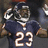 Pixelated image of a person in a dark blue sports jersey with white number 23, holding a football, against a blurred background.