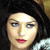 Static 50x50 pixel icon showing a close-up of a person's face with dark hair, light skin tone, and red lips against a black background.