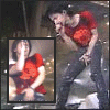 A person in a red shirt and dark pants sings into a microphone on stage, with a smaller inset image of the same pose to the left.