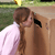 Static 50x50 pixel icon showing two people kissing outdoors with grass and a yellow object in background.