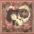 Pixelated image of two figures in close embrace against a floral-patterned background with pink and green tones.