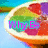 A sliced citrus fruit with green, red, and purple segments against a blue background; text changes across frames.
