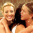 A contact sheet of two animated frames showing two women in a close embrace on the left and green text reading "Original Icons .com" on the right against a dark background.