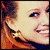 Pixelated close-up of a smiling person with light brown hair in three -aligned showing different angles