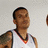 A person in a white basketball jersey with red and black trim appears, then the number 5 is visible on the chest.