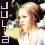 A pixelated image of a person with light brown hair in a white top, with a purple text overlay on the left side.