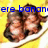 Two pixelated figures with brown hair and light skin sit on a white plate against a yellow background, with blue text partially reading 'ere banana' above them.