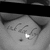A four- shows a grayscale image of a hand holding a paper with handwritten text and a red text overlay reading "MY NEW ADDICTION" on a black background