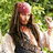 A pixelated image shows a person with long brown hair and a red bandana standing outdoors, next to bold red text reading "I'm Captain Jack Sparrow!" on a black background.