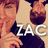 Pixelated image of two figures with reddish-brown hair, one holding a dark object near the face, overlaid with white blocky text 'ZAC' on a beige background.