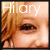 Pixelated close-up of a person's eye and hair with the text "Hilary" overlaid in white, set against warm-toned background colors.