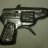 Pixelated image of a handgun with dark grip and metallic barrel against muted gray background.
