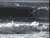 Animated contact sheet of a surfing scene with wave motion and text overlay, displayed in grayscale on a gray background.