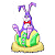 Pixelated cartoon bunny with purple ears and red bow tie standing on a green-and-yellow mound, static single-frame image.