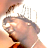 Pixelated static image of a person's face with visible hair, skin tones, and partial facial features against a light background.