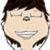 Pixelated cartoon-style face with closed eyes, a broad smile showing teeth, and dark brown hair styled in a short, rounded cut.