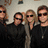 Group of people in dark clothing with green text overlay reading 'BON JOUR OR EVER!!!' on a light background.