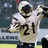 Pixelated image of a football player in white uniform with number 21, holding a ball and raising arm, next to blue text blocks reading LADAINIAN TOMLINSON 5 SICK!!!!