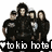Four pixelated figures in dark clothing pose together under a winged emblem with 'Tokyo Hotel' text and Japanese character symbol.