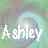 Pixelated static icon with white text 'Ashley' over a blurred multicolored background featuring green, purple, and blue hues.