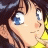 Anime-style character with brown hair and blue eyes in close-up, wearing yellow clothing, next to black background with white text.